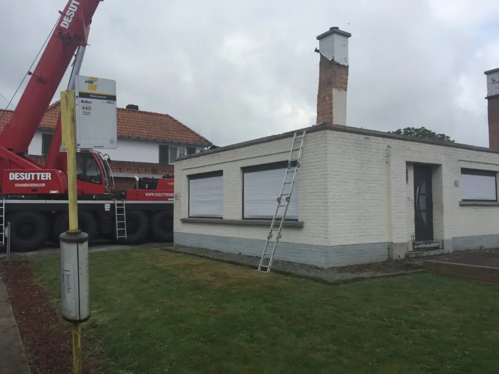 Bestaande woning in Oosterzele na het verwijderen van het hellende dak voor de optopping
