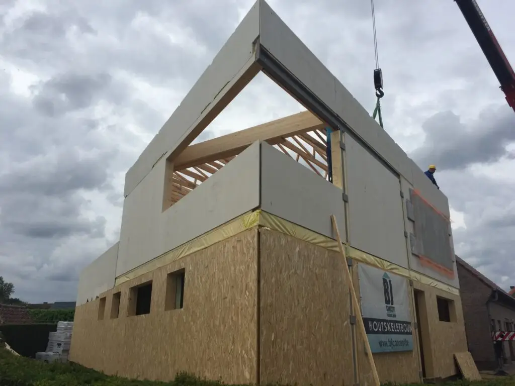Plaatsing van een prefab houtskeletelement boven de gelijkvloerse wanden in Zottegem