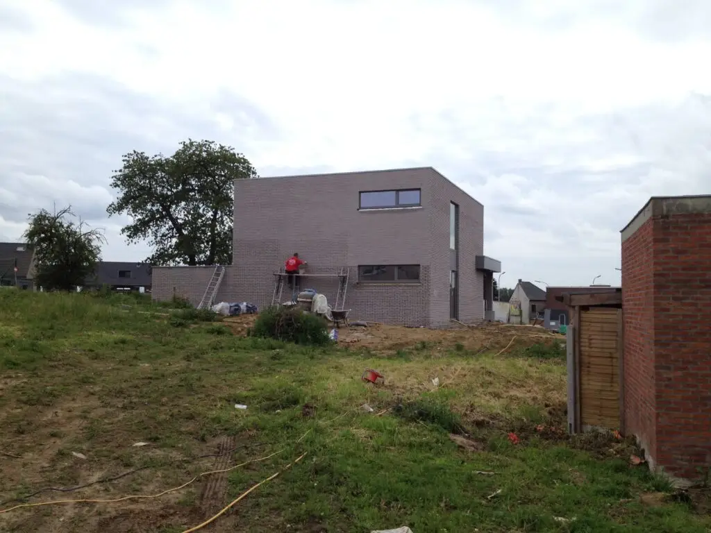Nieuwbouwwoning met lichte gevelsteen tijdens de afwerking in Ophasselt