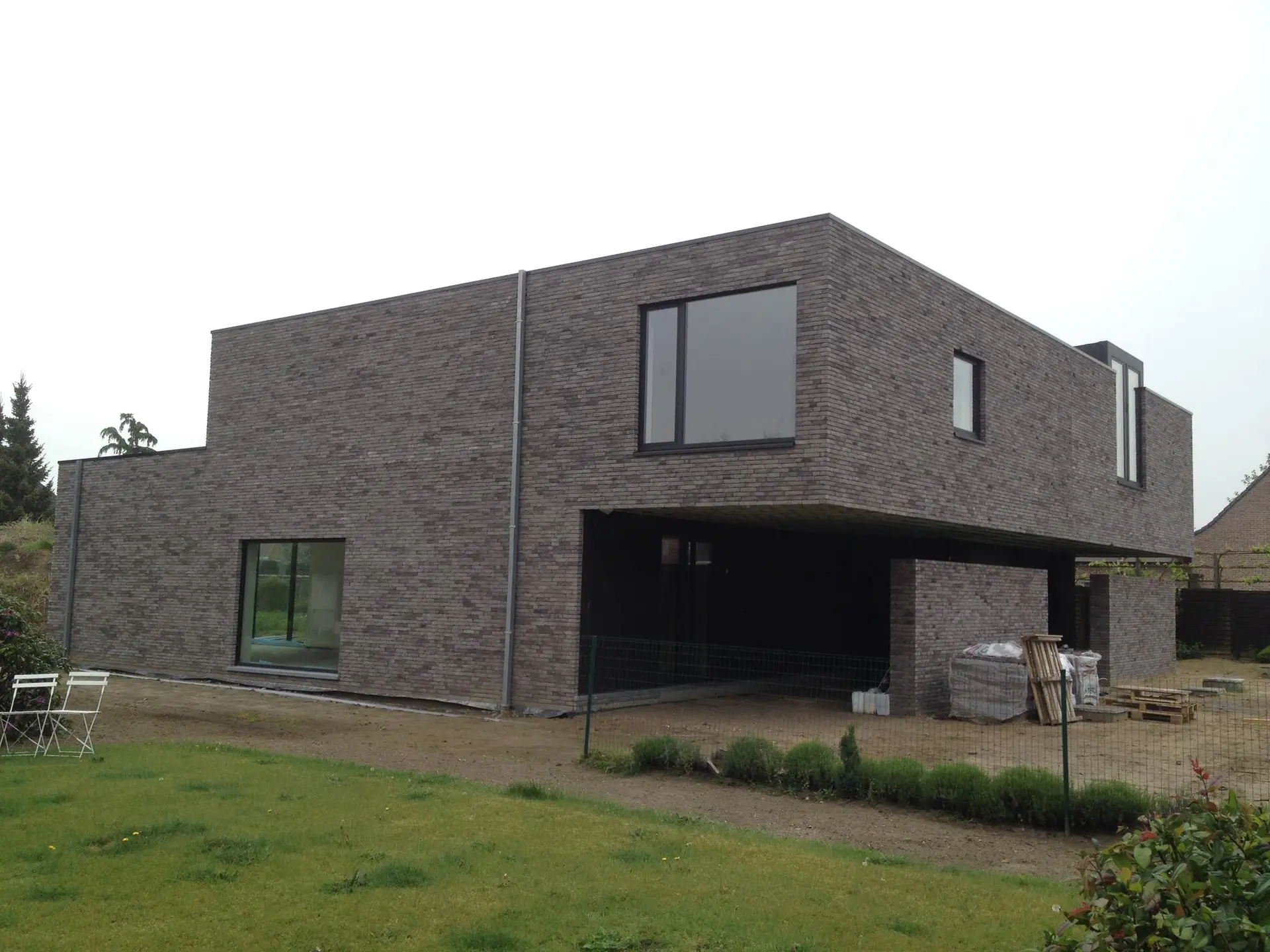 Moderne nieuwbouw met gevelsteen en een plat dak in Zulte